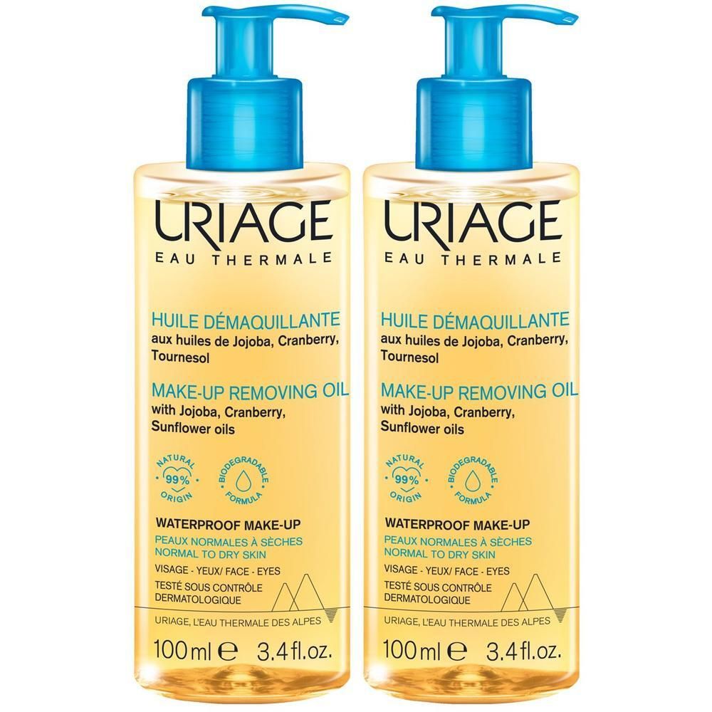 Zwei Flaschen mit blauem Pumpkopf. Aufschrift: URIAGE Eau Thermale. Text: Huile Demaquillante. 99% natürlichen Ursprungs.