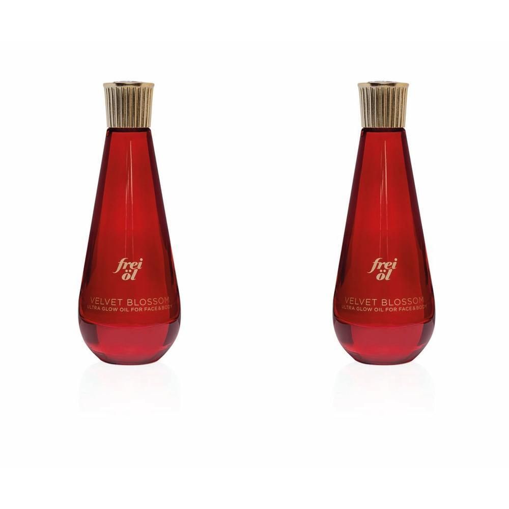 Zwei Flaschen frei öl® ULTRA GLOW ÖL Velvet Blossom. Rote, tropfenförmige Flaschen mit goldenen Verschlüssen.