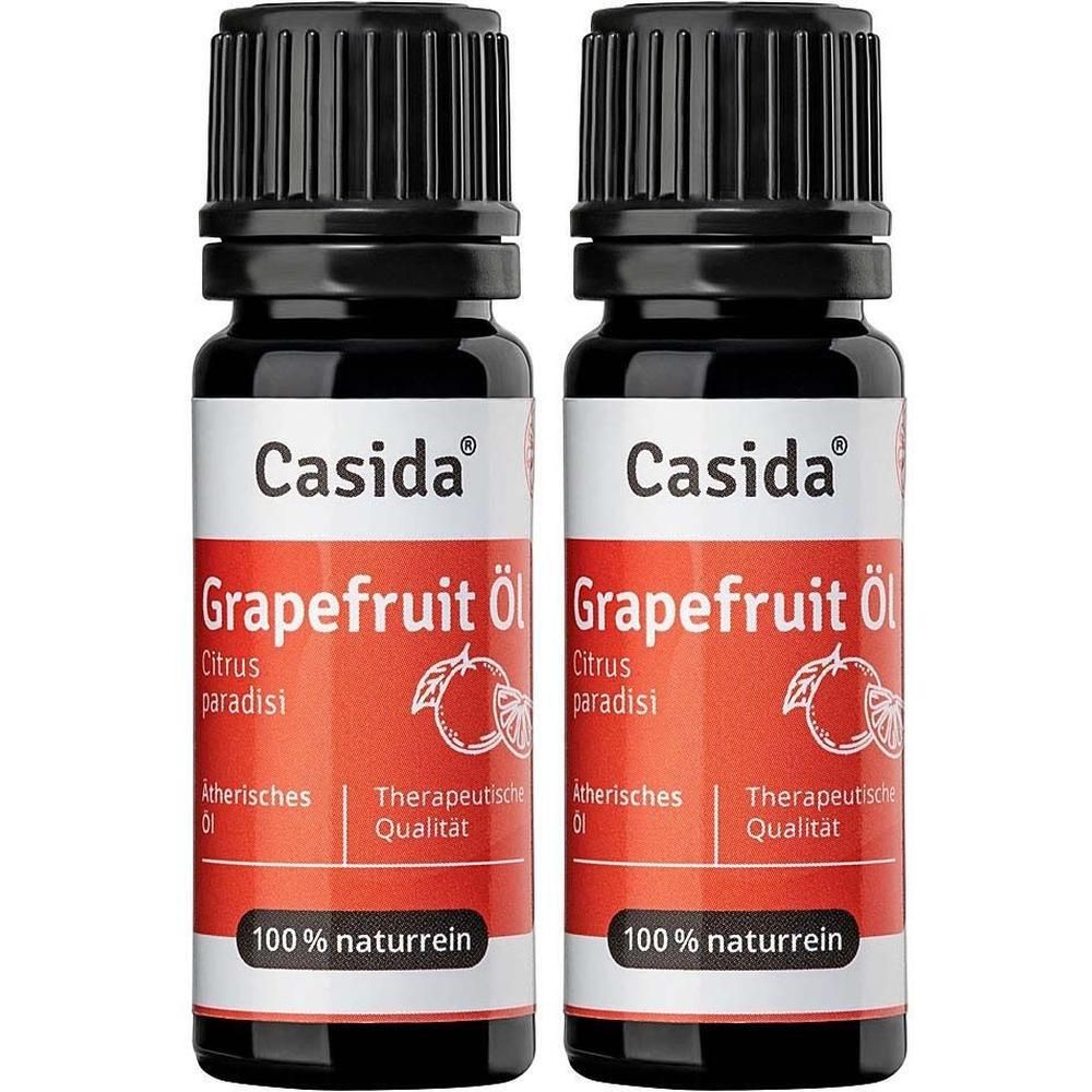 Zwei Flaschen Casida® Grapefruit Öl. Schwarze Kappen, weiße Etiketten mit rotem Band. Aufschrift: Grapefruit Öl, 100% naturrein.