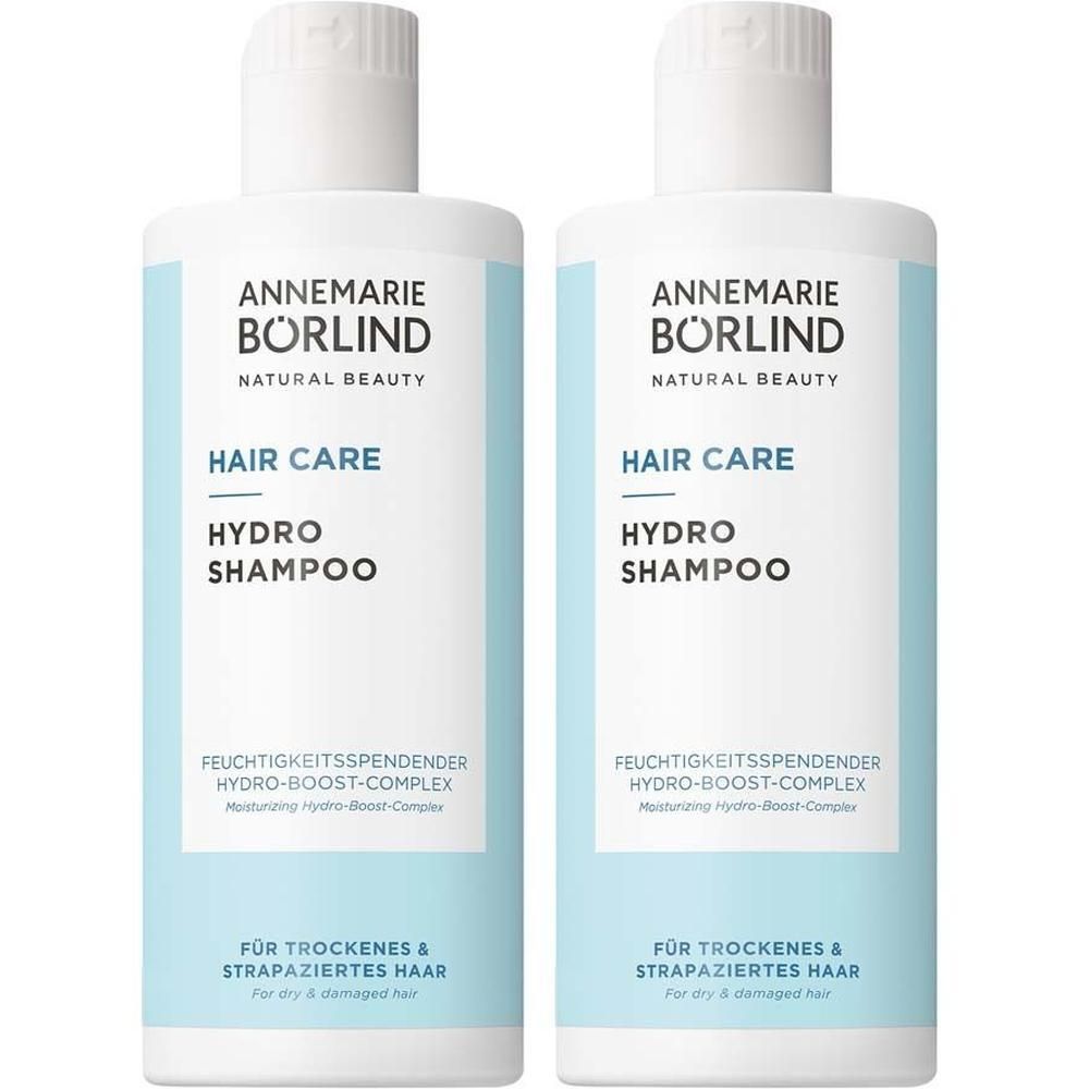 Zwei Flaschen Shampoo. Weißer Deckel, hellblaue Etiketten mit Text. Marke: Annemarie Börlind.
