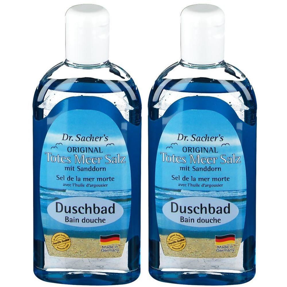 Zwei Flaschen Duschbad mit blauem Inhalt. Aufschrift: Dr. Sacher's Original Totes Meer Salz mit Sanddorn. Mit weißem Deckel und Etikett.