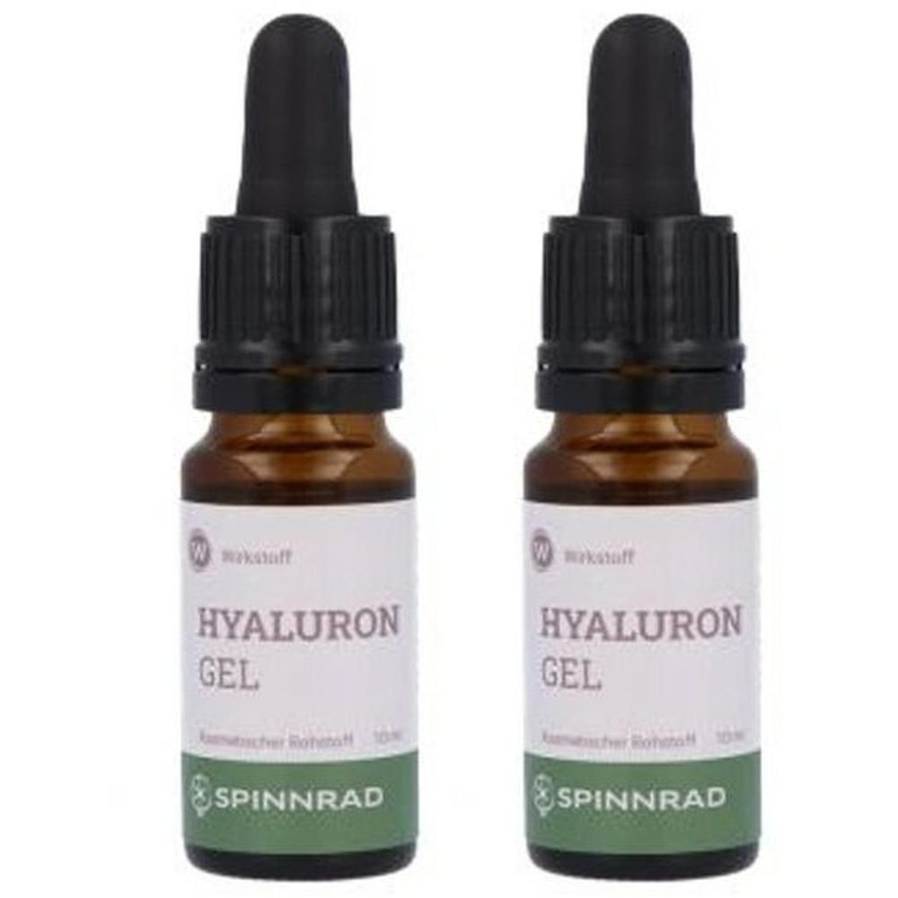 Zwei braune Flaschen mit schwarzen Pipetten. Auf den Etiketten steht "HYALURON GEL" und "SPINNRAD".