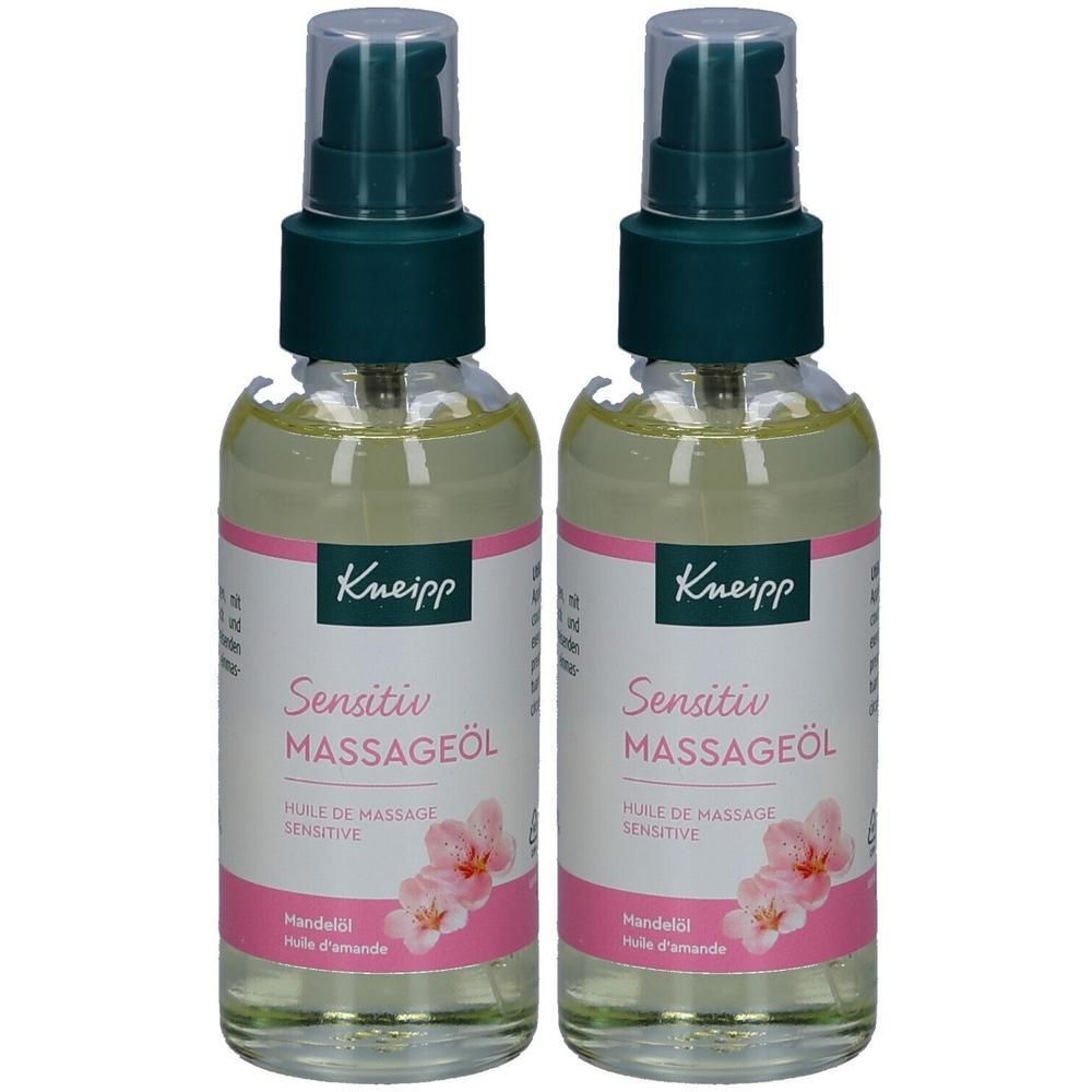 Zwei Flaschen mit Massageöl. Klare Flüssigkeit in Glasflaschen mit grünem Pumpverschluss. Etikett mit Produktnamen und Blüten.