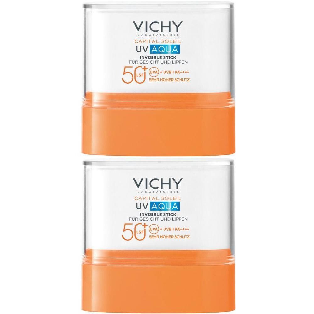 Zwei Sonnenschutz-Sticks. Weißer Behälter mit orangefarbenem Boden. Vichy-Logo und Produktinformationen.