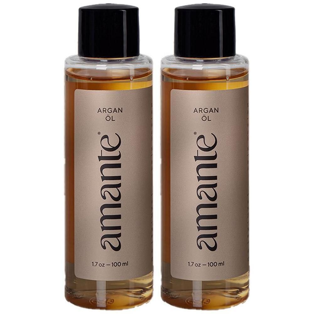 Zwei Flaschen Arganöl. Aufschrift "amante" und "Arganöl". Schwarzer Deckel, transparente Flasche mit goldfarbenem Öl.