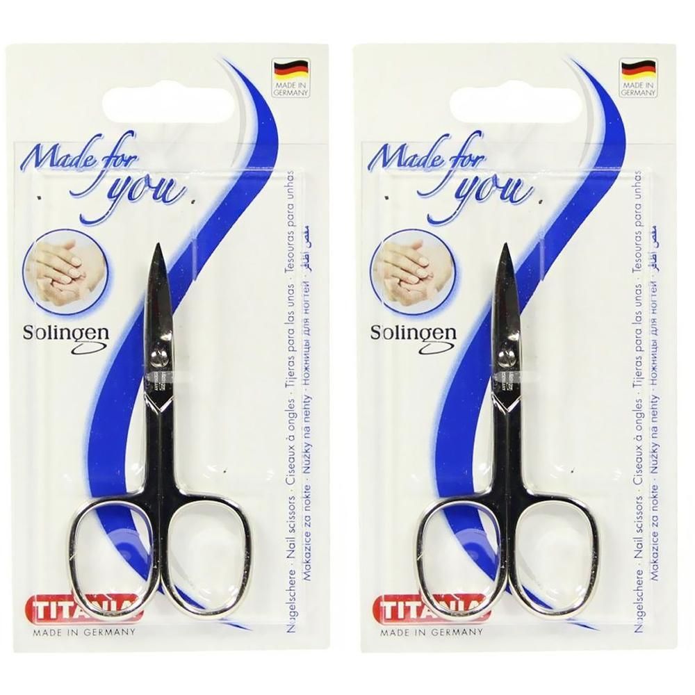 Nagelschere in Verpackung. Schwarze Griffe, silberne Klingen. Aufschrift: Solingen, Made in Germany. Marke: TITANIA.