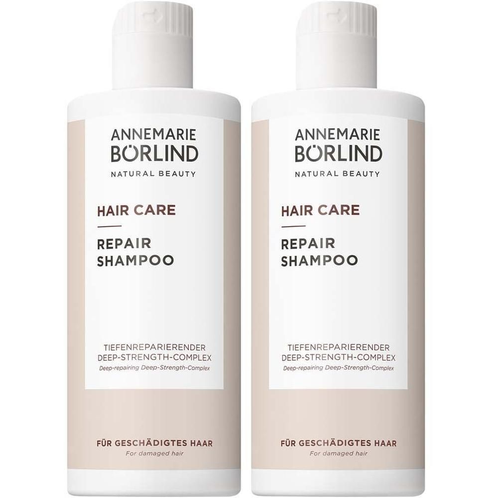 Zwei Flaschen ANNEMARIE BÖRLIND Hair Care Repair Shampoo. Weiße Flaschen mit beigem Etikett. Schwarze Schrift.