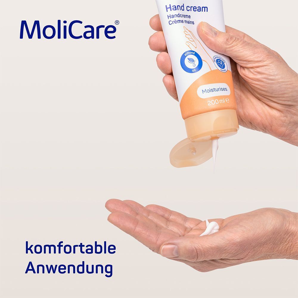 Handcreme wird aus Tube in Hand gedrückt. Text: komfortable Anwendung. Produkt: MoliCare Skin Handcreme.