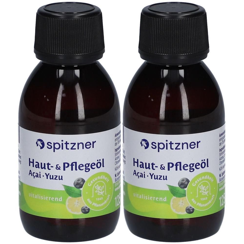 Zwei Flaschen Haut- & Pflegeöl Acai-Yuzu. Braune Glasflaschen mit schwarzem Schraubverschluss und Etikett. Marke: Spitzner.