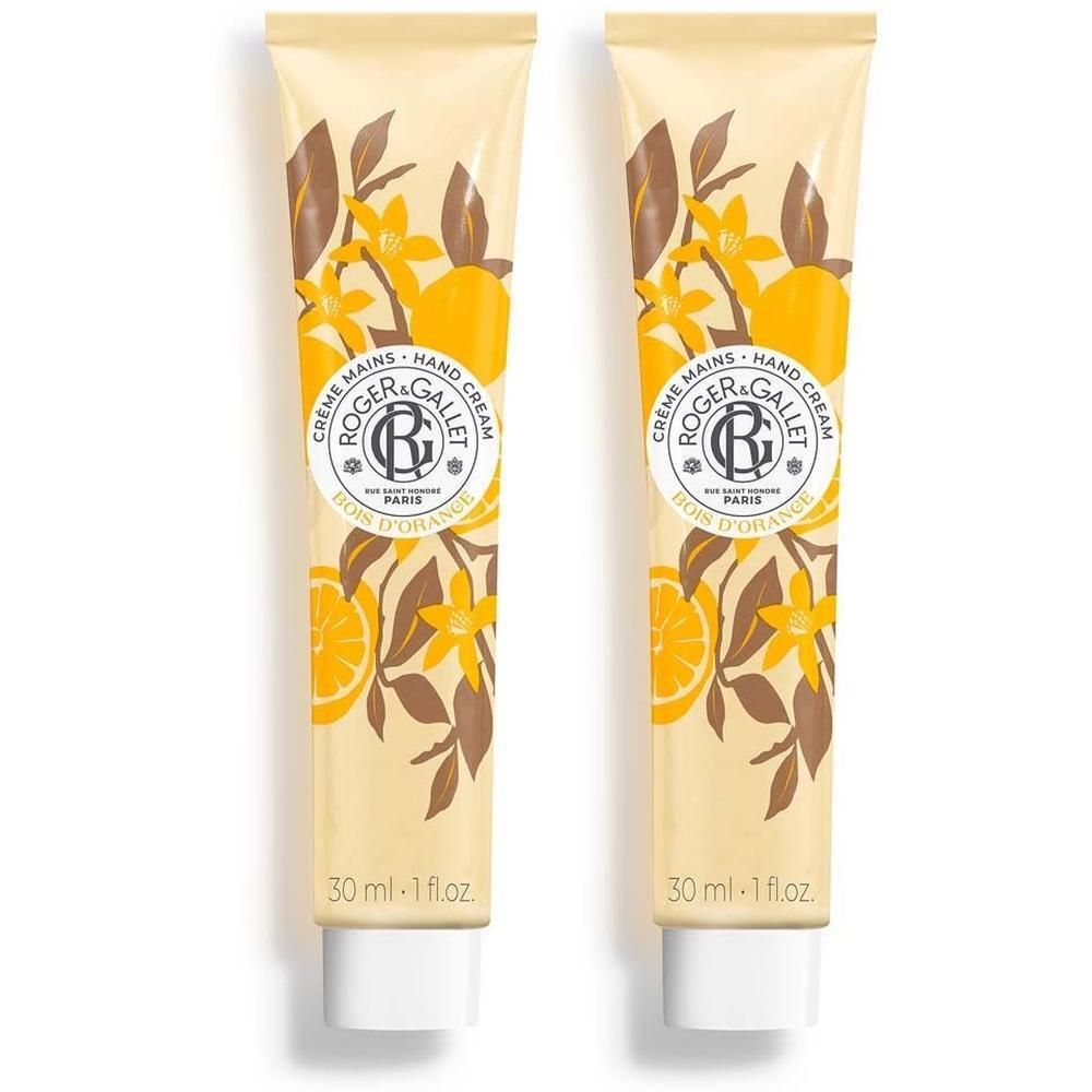 Zwei Tuben Handcreme. Beige Grundfarbe, gelbe und braune Illustrationen. Aufschrift: Crème Mains, Roger & Gallet, Bois d'Orange.