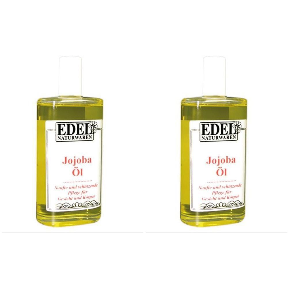 Zwei Flaschen Jojoba-Öl. Aufschrift: EDEL NATURWAREN, Jojoba Öl. Flaschen mit weißem Verschluss, gelbliche Flüssigkeit.
