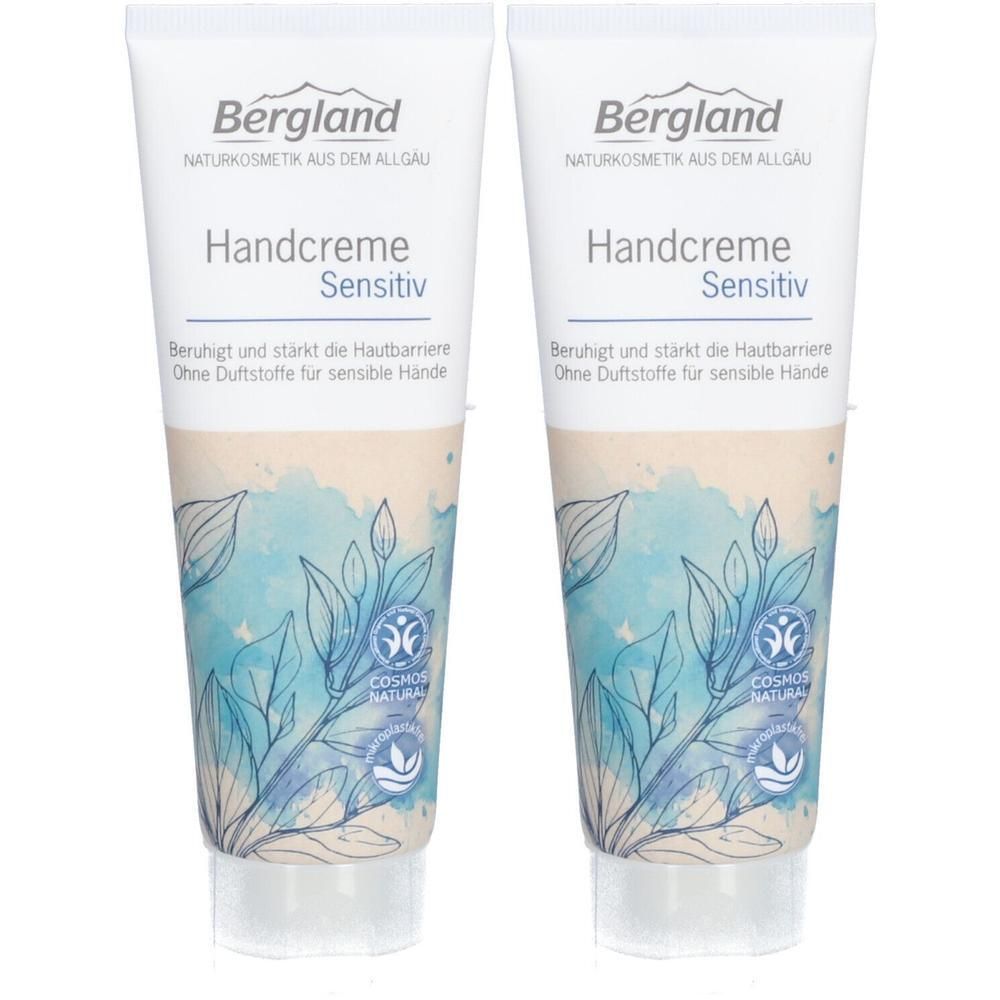 Zwei Tuben Handcreme Sensitiv. Weiß, mit blau-beigen floralen Mustern. Text: Bergland, Handcreme Sensitiv, COSMOS NATURAL.