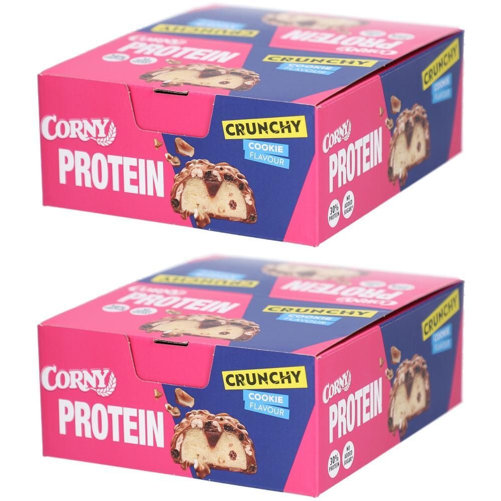 Zwei Kartons mit Corny Protein Crunchy Cookie. Rosa und weiße Verpackung mit Produktabbildung und Schriftzug.