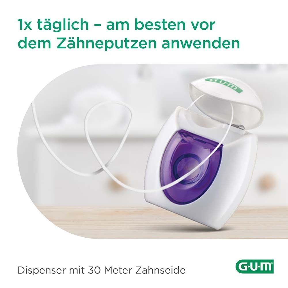 GUM Expanding Floss-Behälter, geöffnet. Weiße Zahnseide wird herausgezogen. GUM-Logo unten rechts.