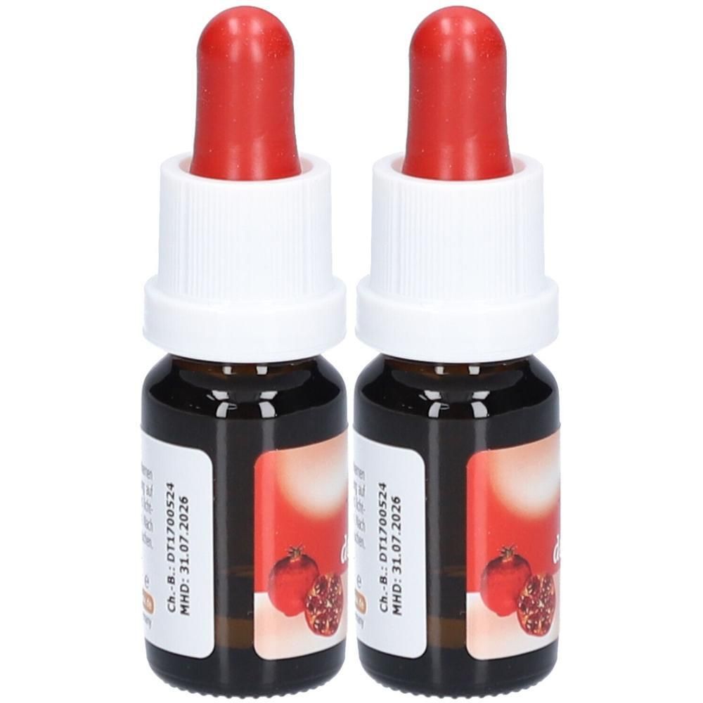 Zwei kleine Fläschchen mit roter Pipette und weißem Verschluss. Aufkleber mit Granatapfel-Motiv und Text.