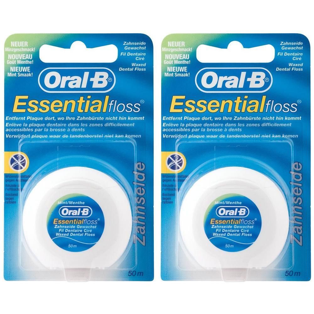 Zwei Packungen Zahnseide. Blaue Verpackung mit weißer Spule. Marke: Oral-B Essentialfloss. Text: Gewachst, Mint.