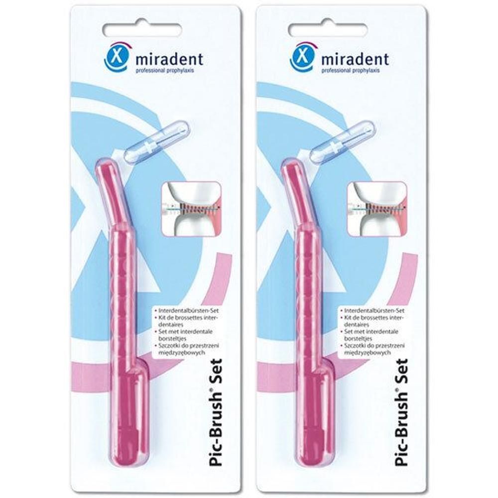Zwei Packungen mit pinkfarbenen Pic-Brush® Sets. Jedes Set enthält eine Zahnbürste und eine transparente Schutzhülle. Das Logo von miradent ist sichtbar.