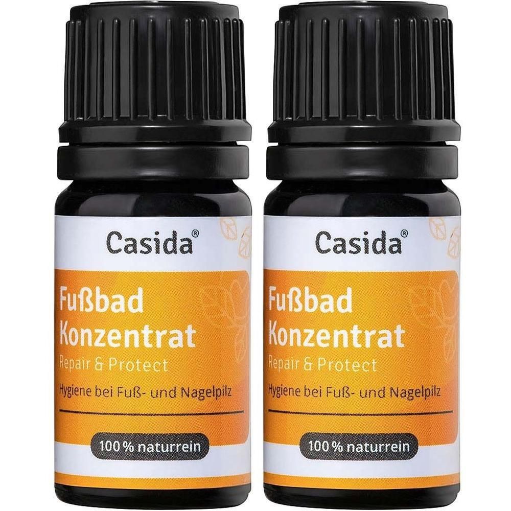 Zwei Flaschen FUSSBAD Konzentrat. Schwarze Deckel, orangefarbene Etiketten mit Text. Marke: Casida. Aufschrift: Repair & Protect, 100% naturrein.