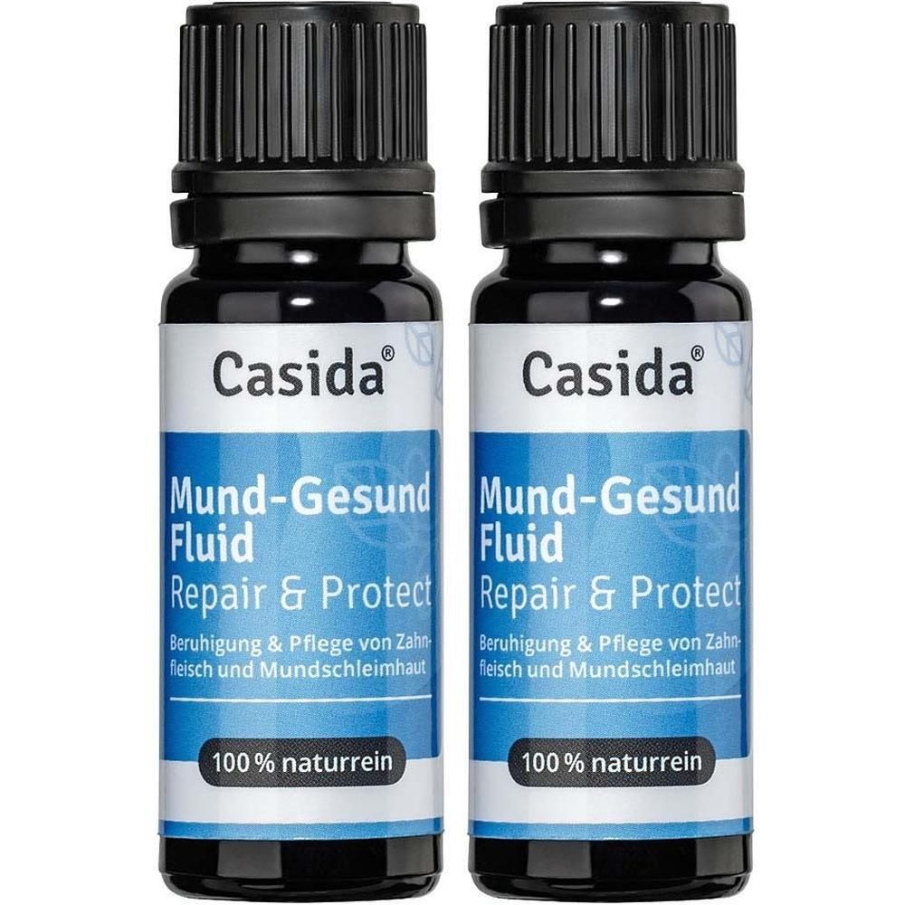 Zwei Flaschen Mund-Gesund Fluid. Blaue Etiketten mit weißer Schrift. Marke Casida. Schwarze Deckel.