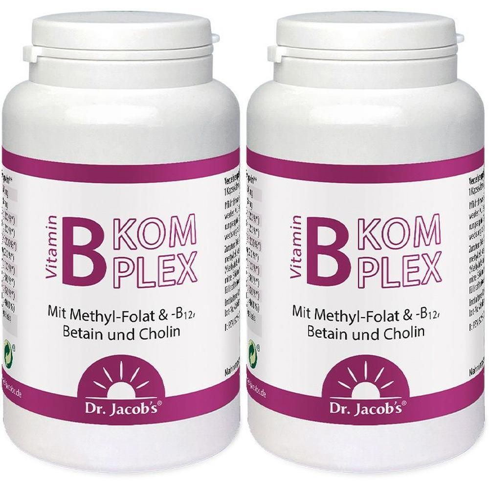 Zwei weiße Flaschen mit lila Etikett. Aufschrift: Vitamin B-Komplex. Marke: Dr. Jacob's.