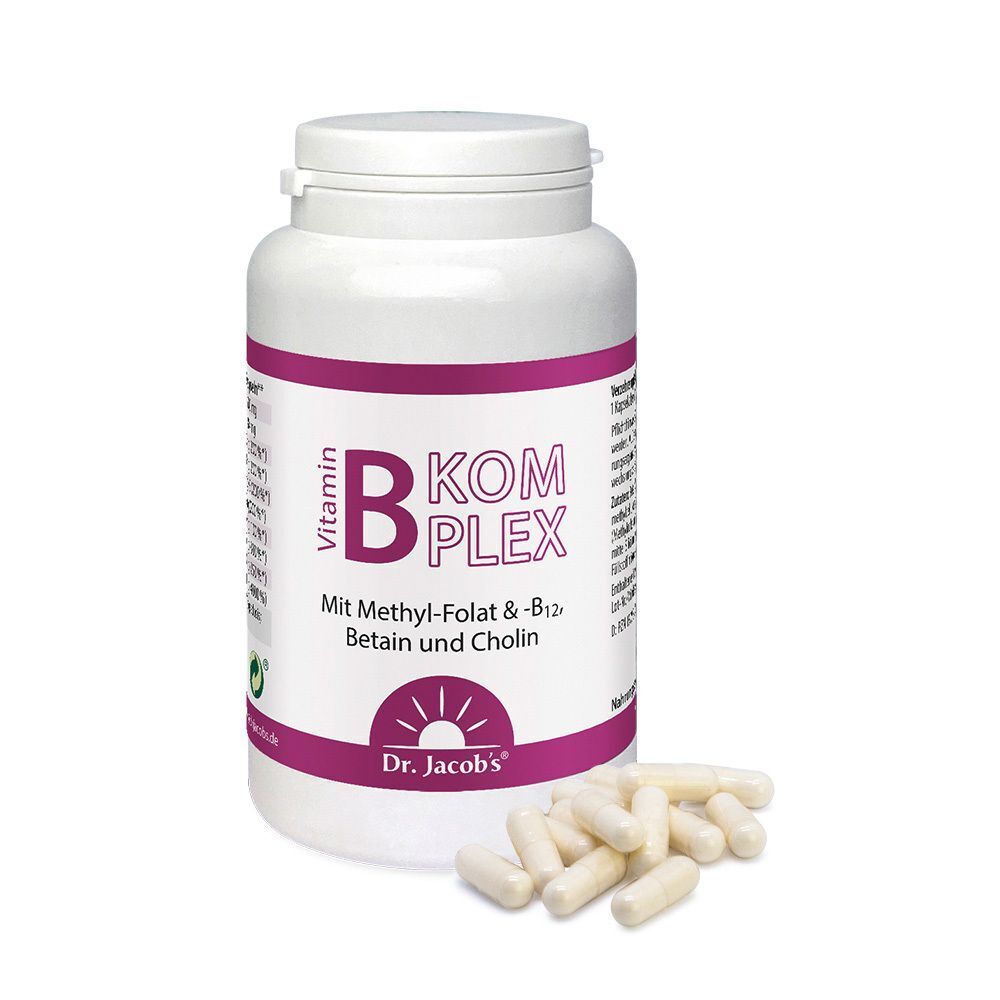 Weiße Flasche mit lila Etikett und Kapseln daneben. Aufschrift: Vitamin B-Komplex. Marke: Dr. Jacob's.