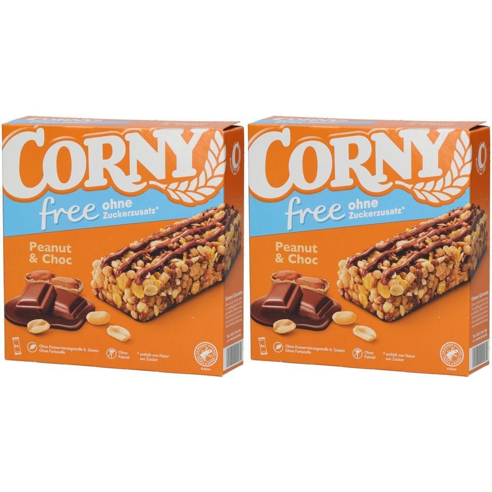 Zwei Schachteln mit Corny free Erdnuss-Schoko. Aufschrift "free ohne Zuckerzusatz". Abgebildet sind Riegel, Erdnüsse und Schokolade.