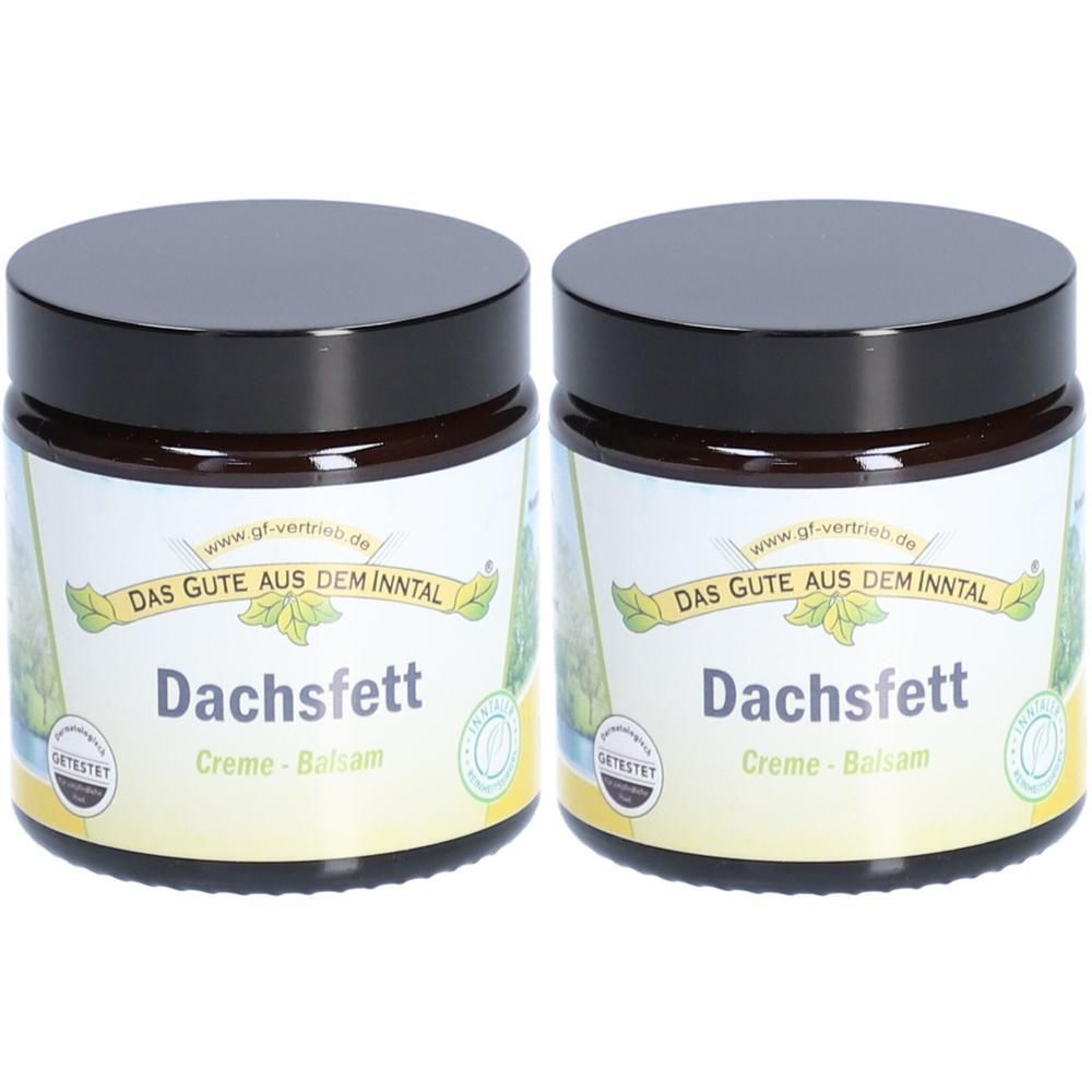 Zwei braune Tiegel mit schwarzen Deckeln. Auf den Etiketten steht "Dachsfett Creme-Balsam".