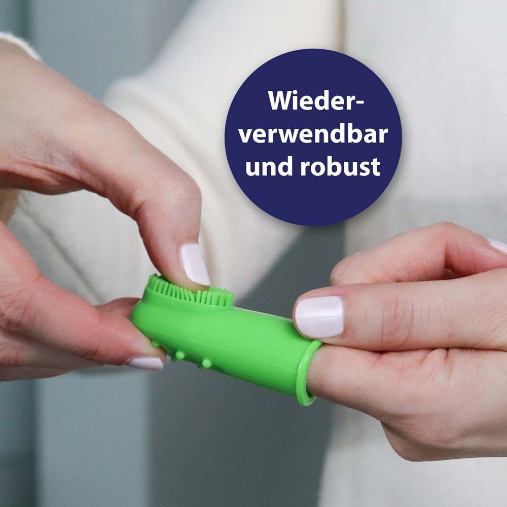 Fingerbürste auf Finger. Grüne Bürste. Text: Wiederverwendbar und robust.
