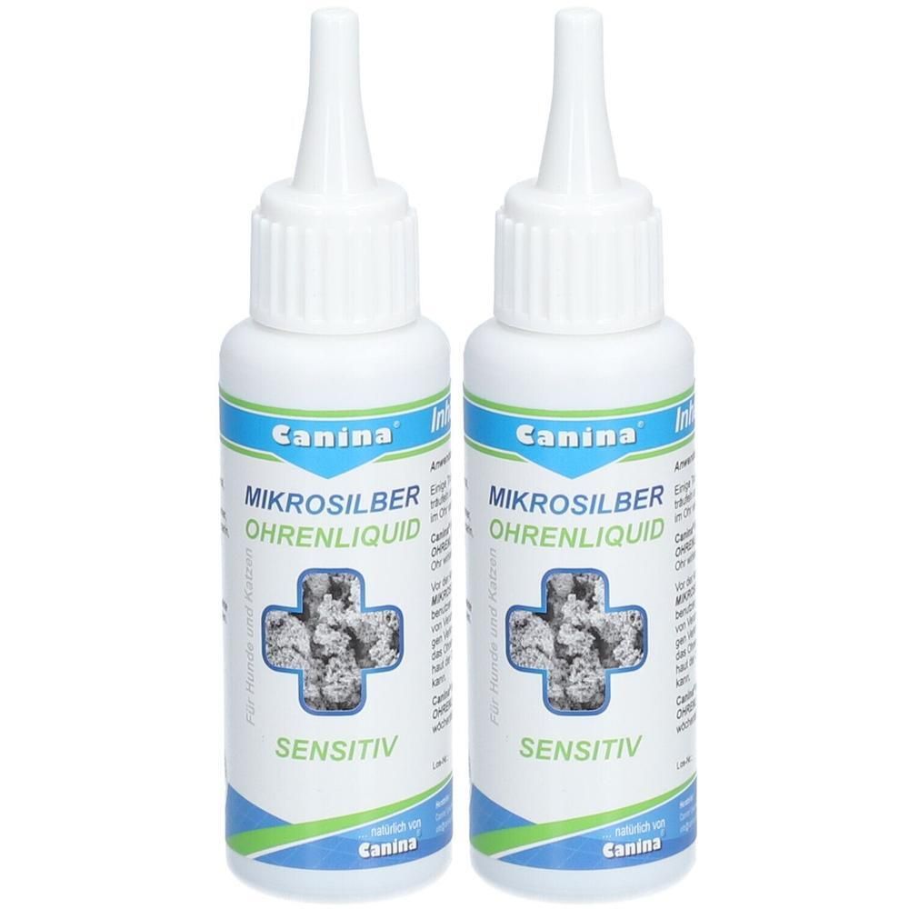 Zwei weiße Flaschen mit Spritzaufsatz. Aufschrift: Canina, Mikrosilber Ohrenliquid, Sensitiv. Kreuz-Symbol mit grauem Inhalt.