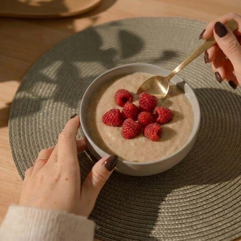 Schüssel mit nu3 Vegan Protein Rice Pudding und Himbeeren.