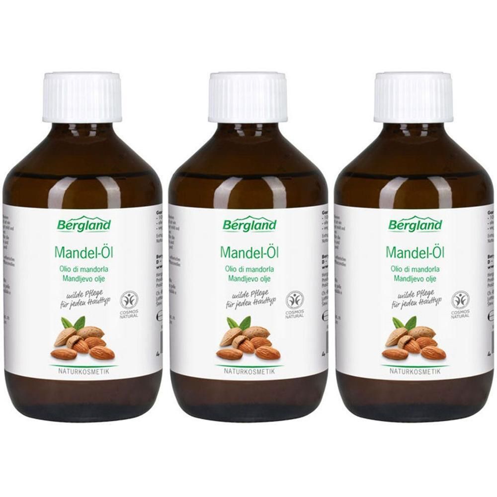 Drei Flaschen Bergland Mandel-Öl mit Etiketten, die Mandeln und Blätter zeigen. Naturkosmetik.