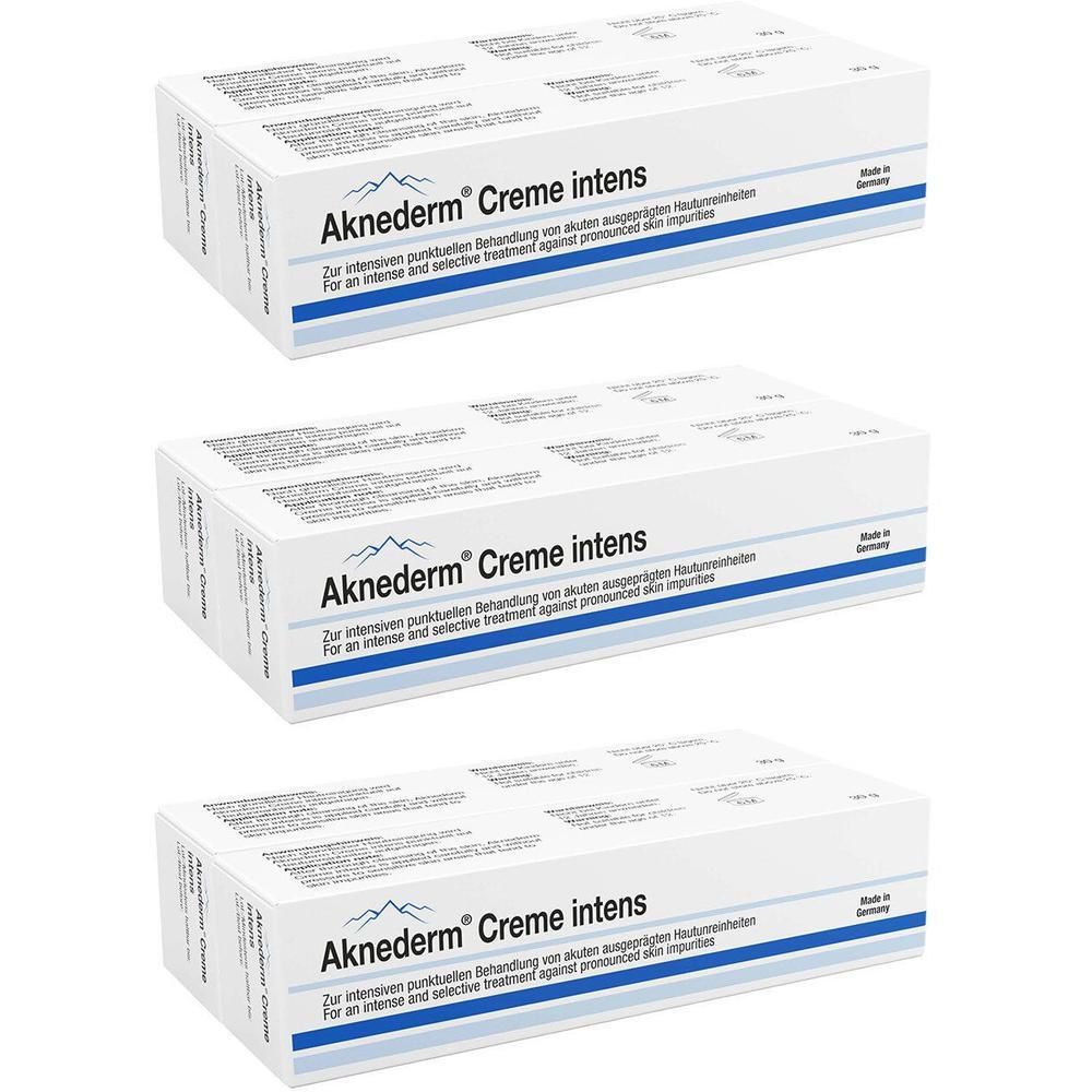 Drei Packungen Aknederm Creme intens, weiße Kartons mit blauer Schrift.