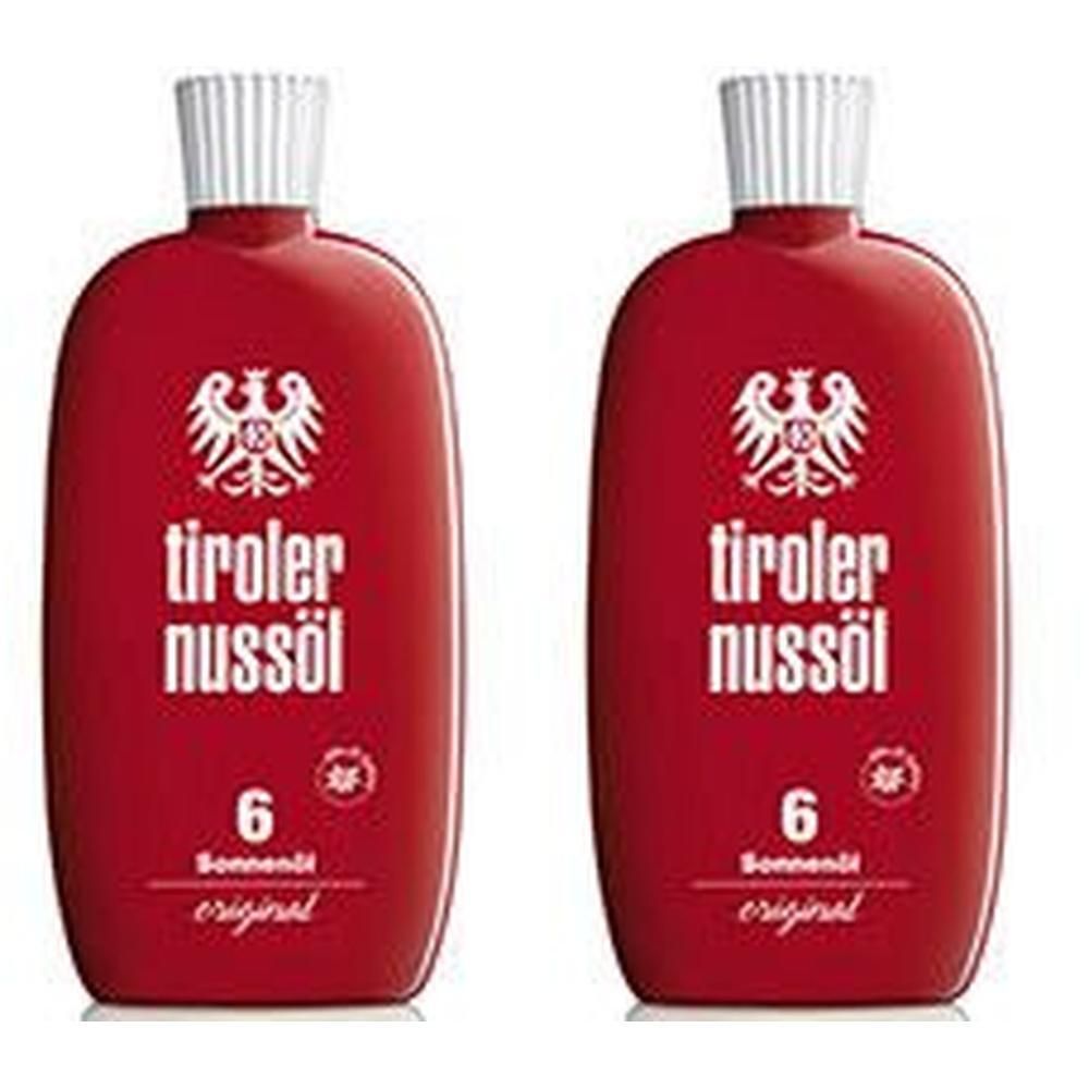 Zwei rote Flaschen Tiroler Nussöl Sonnenöl LSF 6 mit weißem Aufdruck und weißem Verschluss.