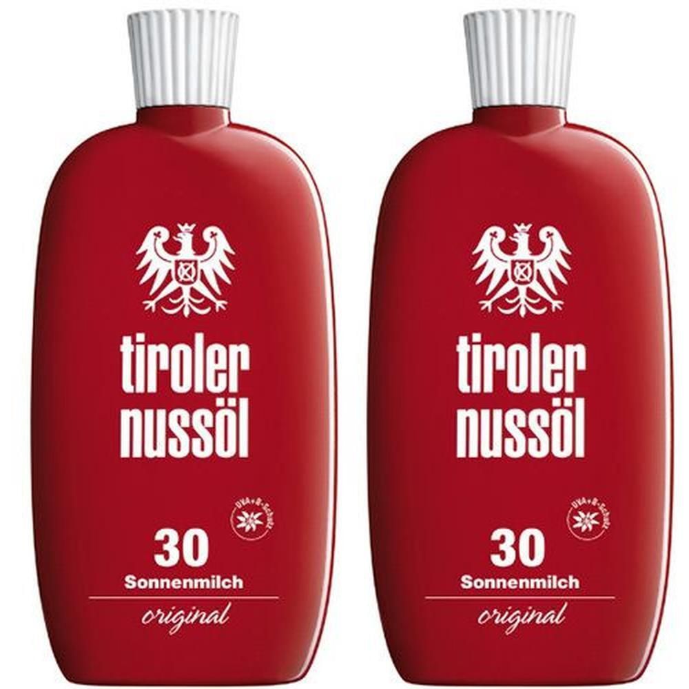 Zwei rote Flaschen Tiroler Nussöl Sonnenmilch LSF 30.