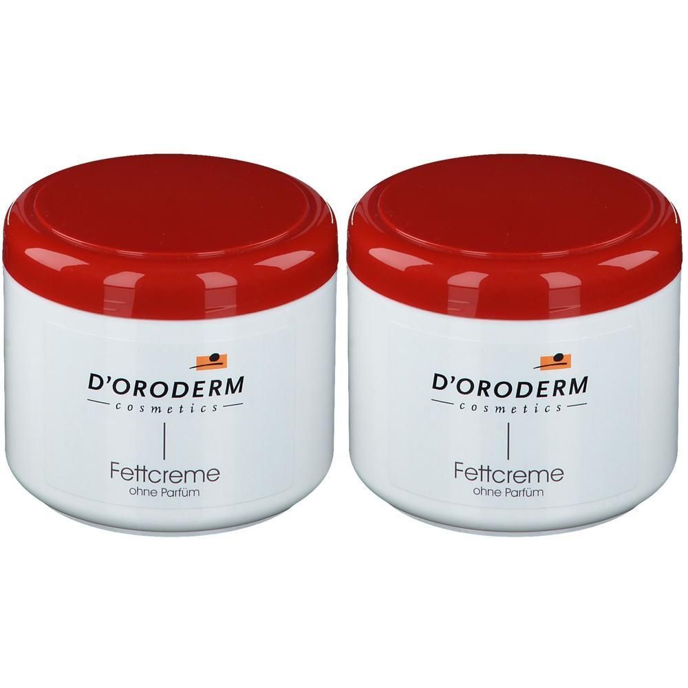 Zwei weiße D'ORODERM Fettcreme-Tiegel mit roten Deckeln.