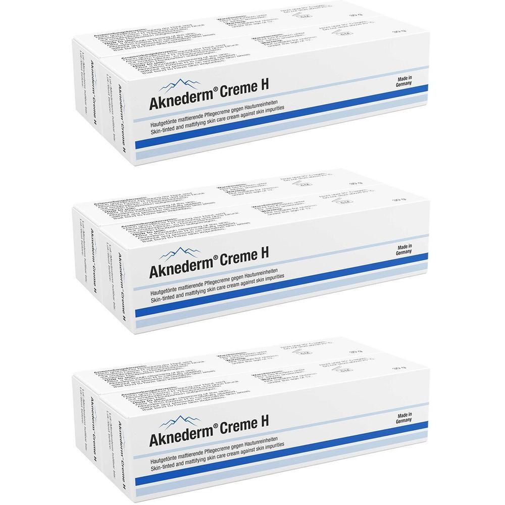 Drei Packungen Aknederm® Creme H, weiße Kartons mit blauen Streifen und Bergmotiv.