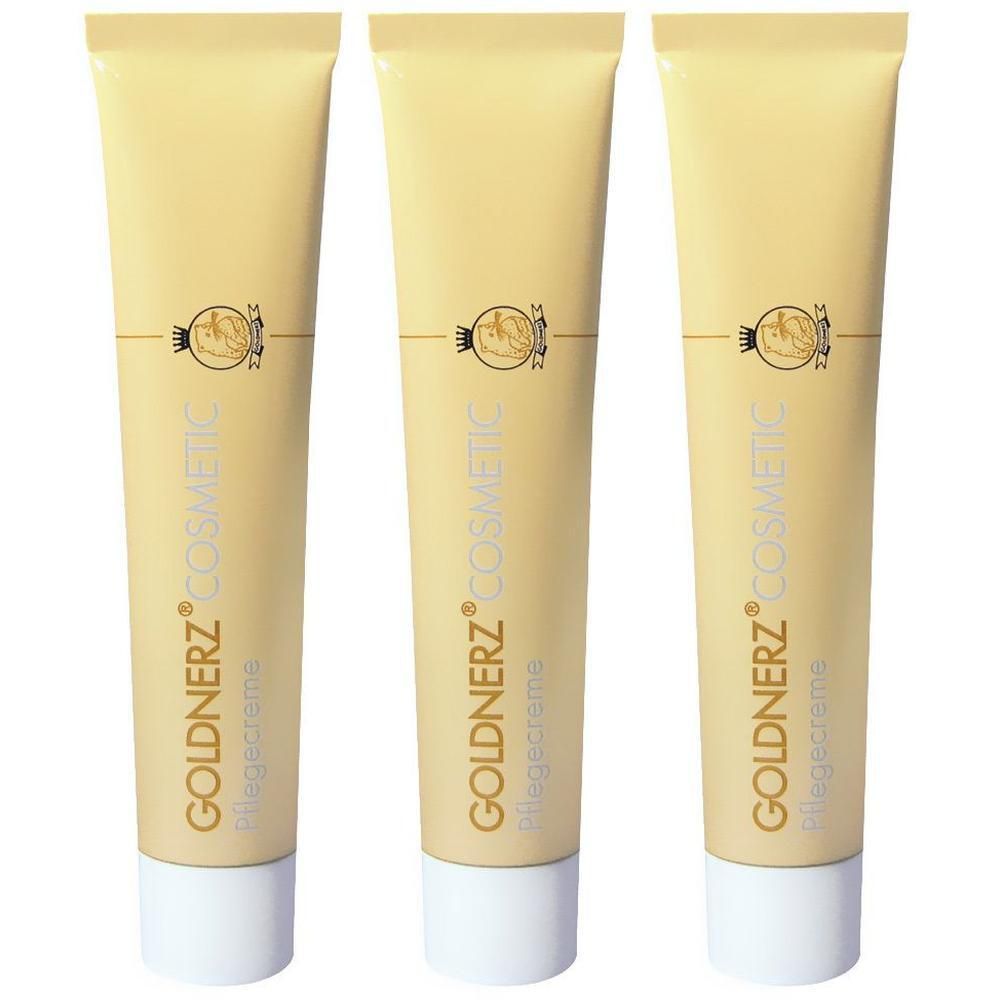 Drei goldene Tuben GOLDNERZ® Pflegecreme mit weißem Verschluss und Logo.
