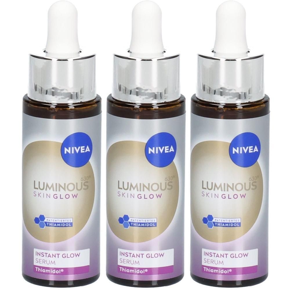Drei NIVEA Luminous630® Instant Glow Serum Flaschen mit Pipetten. Silberne und weiße Etiketten mit Produktnamen.