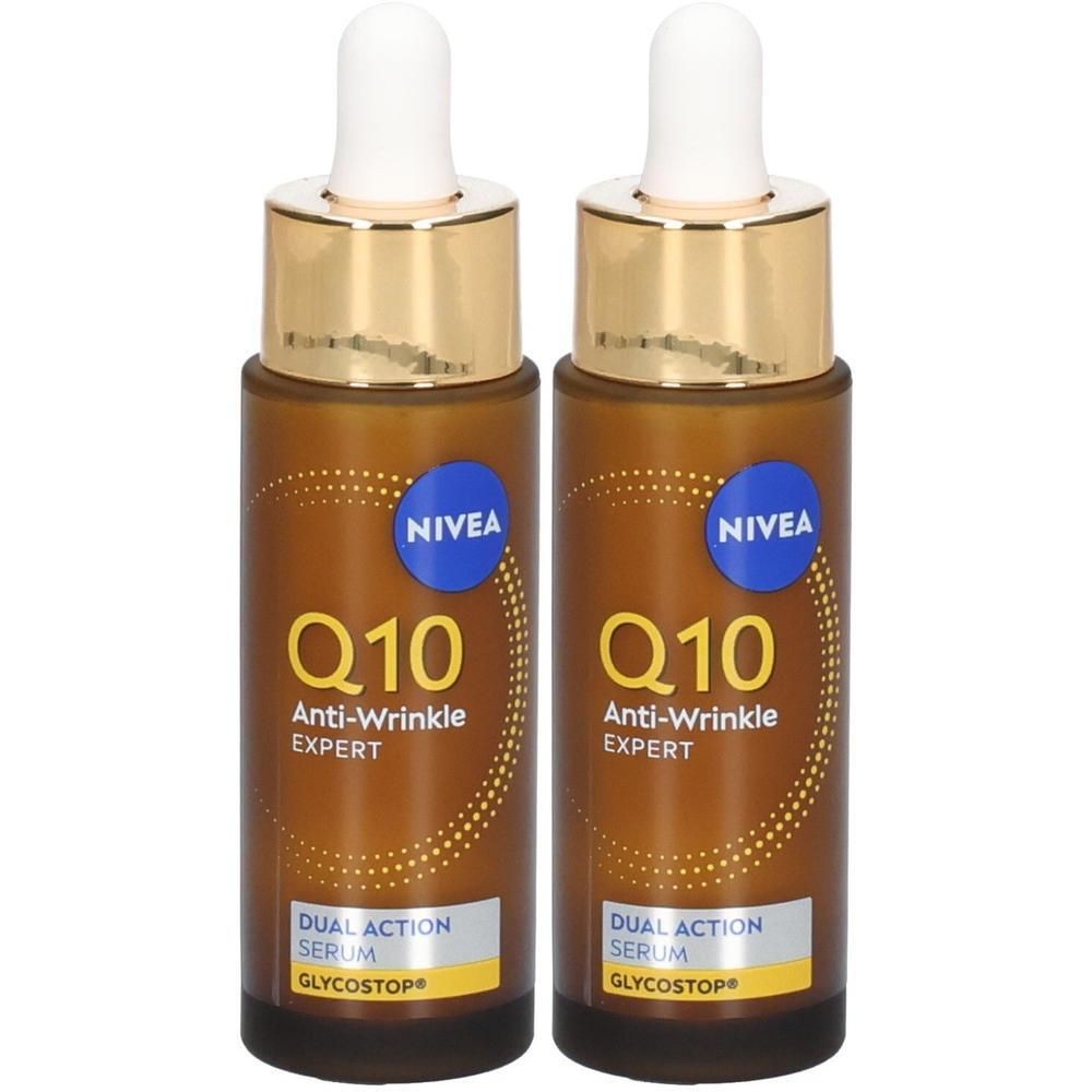 Zwei NIVEA Q10 Anti-Falten EXPERT Dual Action Seren in braunen Glasflaschen mit Pipetten. Goldener Ring und weißer Verschluss.