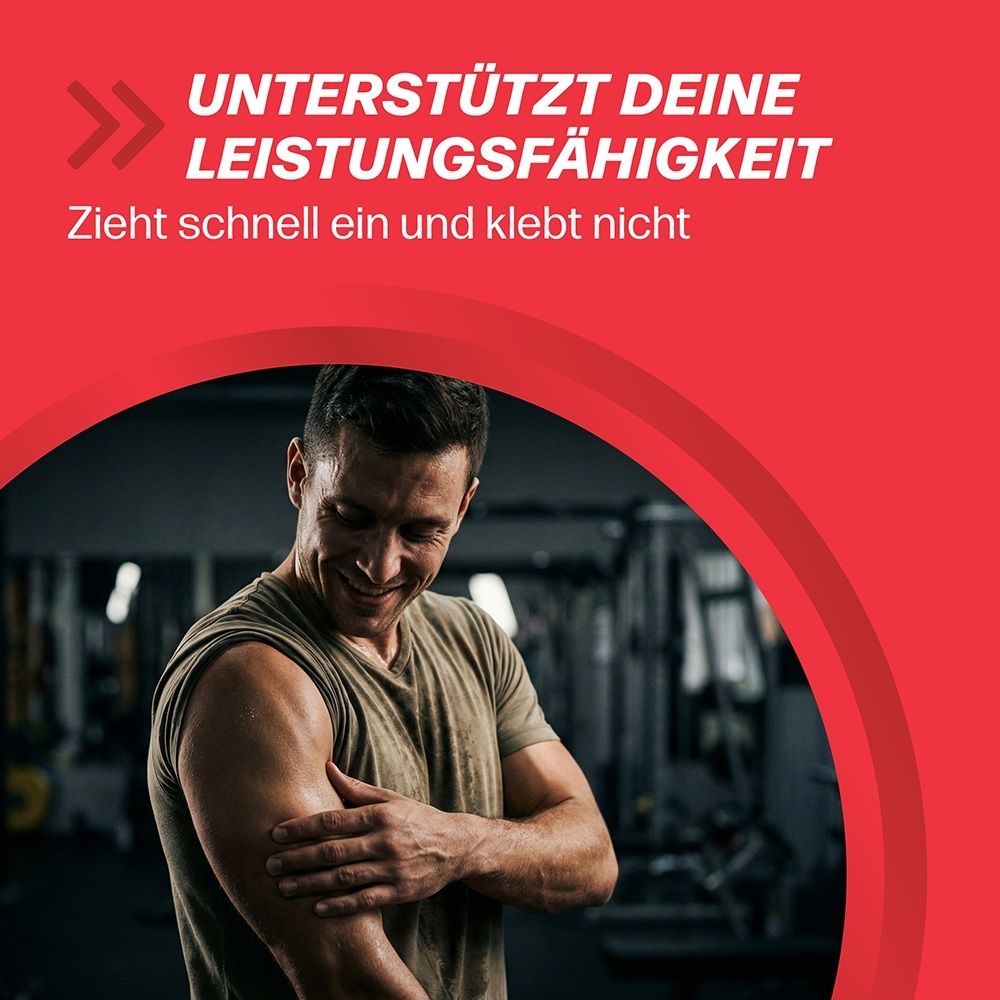 Mann reibt sich den Bizeps in einem Fitnessstudio. Text: Unterstützt deine Leistungsfähigkeit.