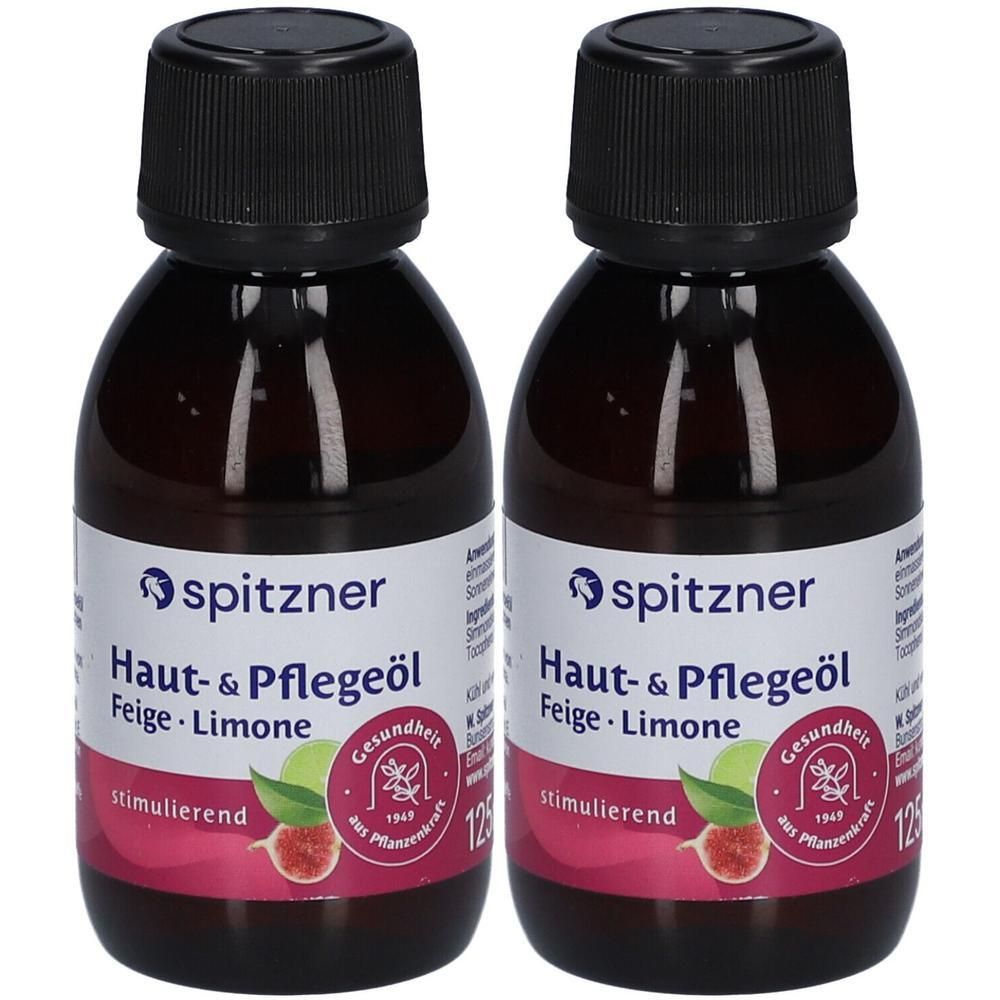Zwei Flaschen Spitzner Haut- & Pflegeöl Feige-Limone mit schwarzen Schraubverschlüssen. Etikett mit Produktnamen und Abbildung einer Feige und Limone.