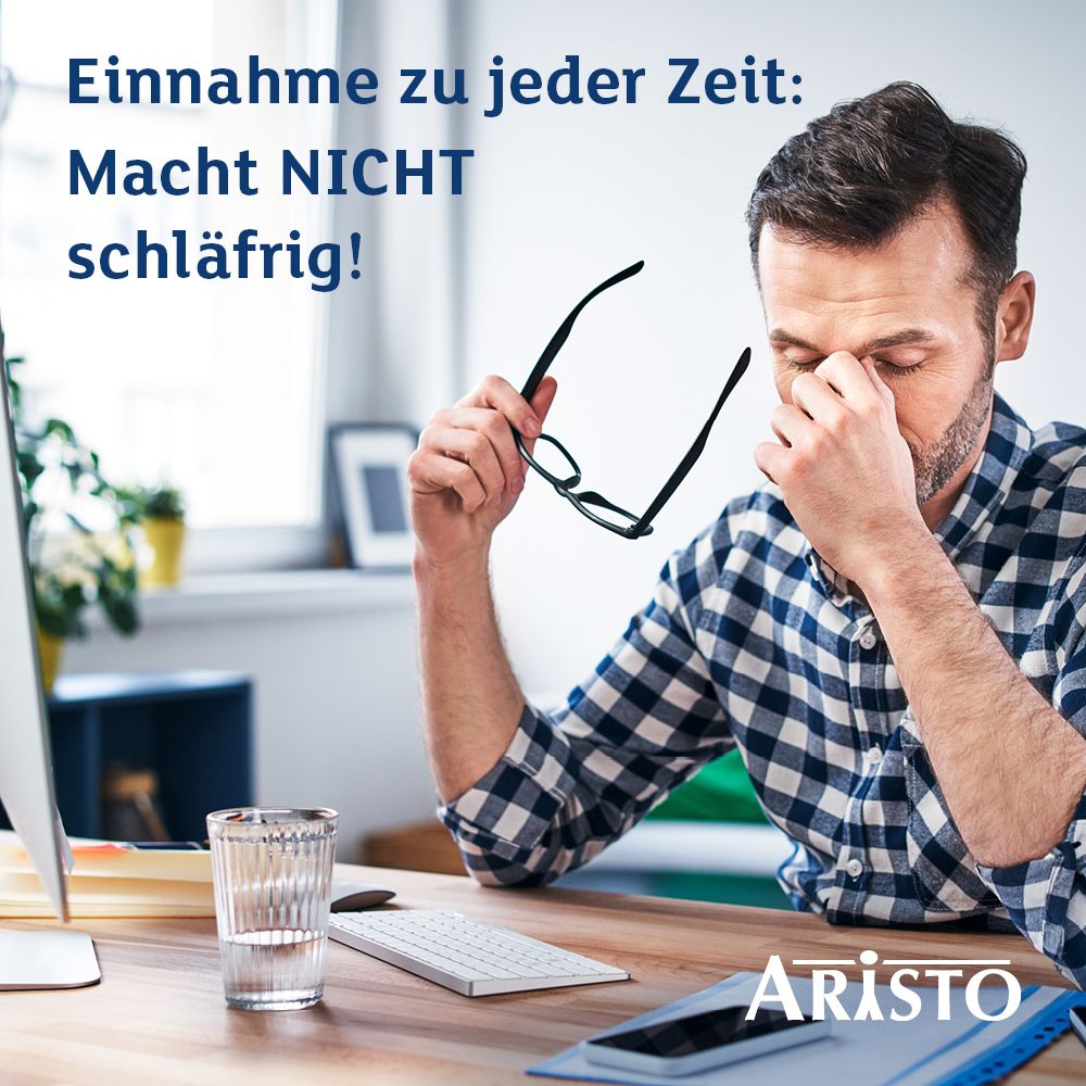 Mann am Schreibtisch, hält Brille. Text: 'Einnahme zu jeder Zeit: Macht NICHT schläfrig!'. Logo Aristo.