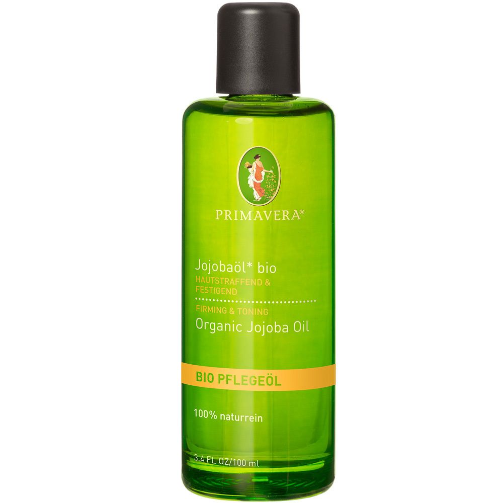 Grüne Flasche mit schwarzem Deckel. Aufschrift: PRIMAVERA, Jojobaöl bio, Organic Jojoba Oil. Orangefarbener Streifen mit Text.