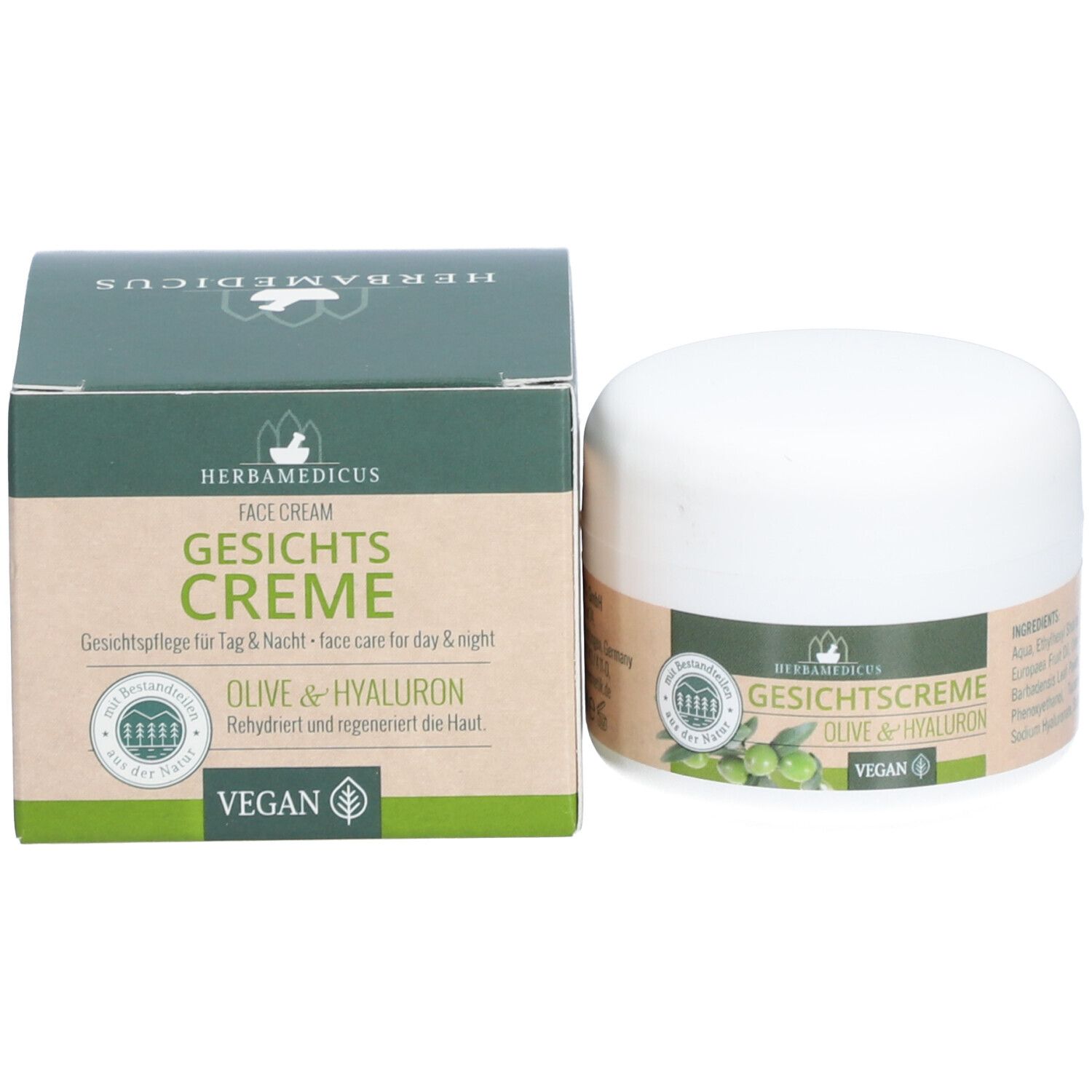 Creme-Dose und Karton. Aufschrift: Herbamedicus Gesichtscreme. Grün-braune Verpackung. Vegan-Siegel.