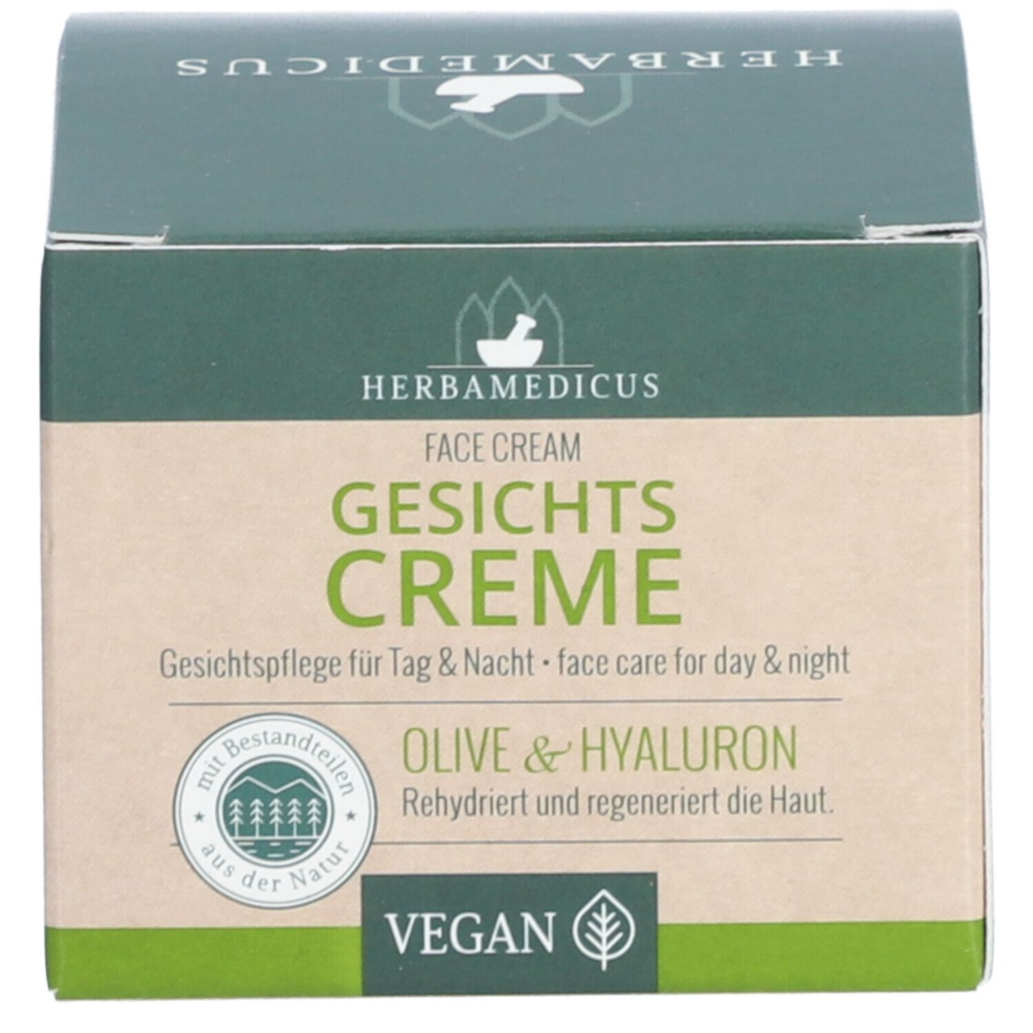 Karton. Aufschrift: Herbamedicus Gesichtscreme. Grün-braune Verpackung. Vegan-Siegel. Text: Gesichtspflege für Tag & Nacht.
