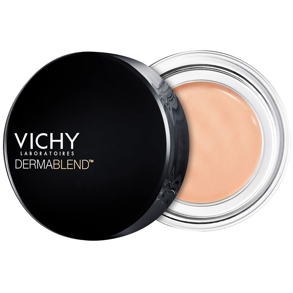 Vichy Dermablend Korrekturfarbe Apricot, offener Tiegel. Schwarzer Deckel, transparente Dose mit apricotfarbenem Produkt.