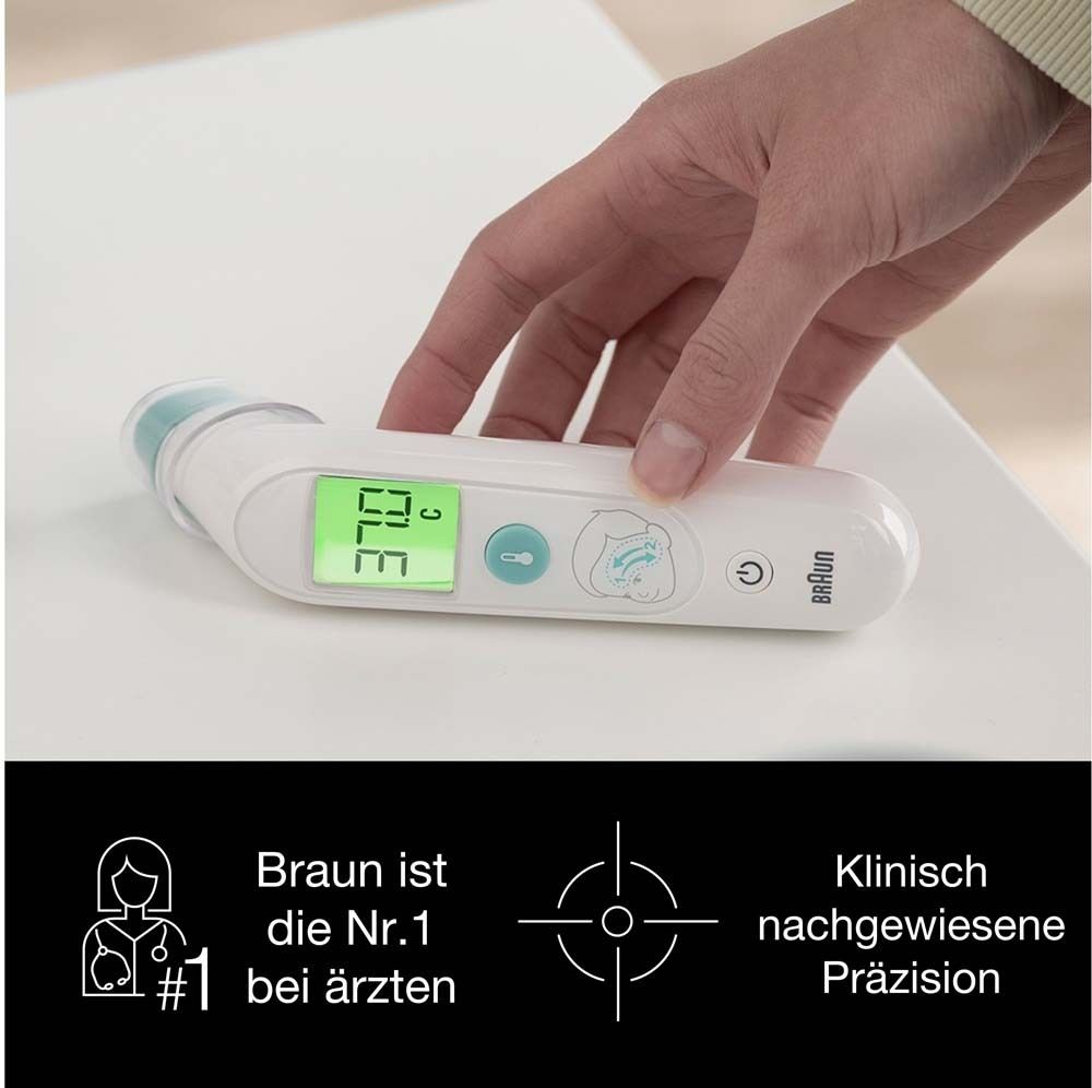 Digitales Thermometer auf weißer Oberfläche. Display zeigt 37.3°C. Person berührt das Gerät. Text: Braun, klinisch geprüft.