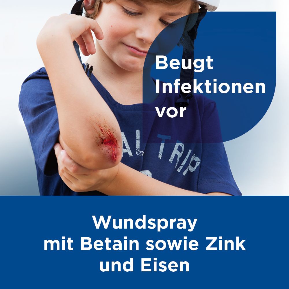 Kind mit Wunde am Ellenbogen. Text: Beugt Infektionen vor. Wundreinigungsspray mit Zink und Eisen.