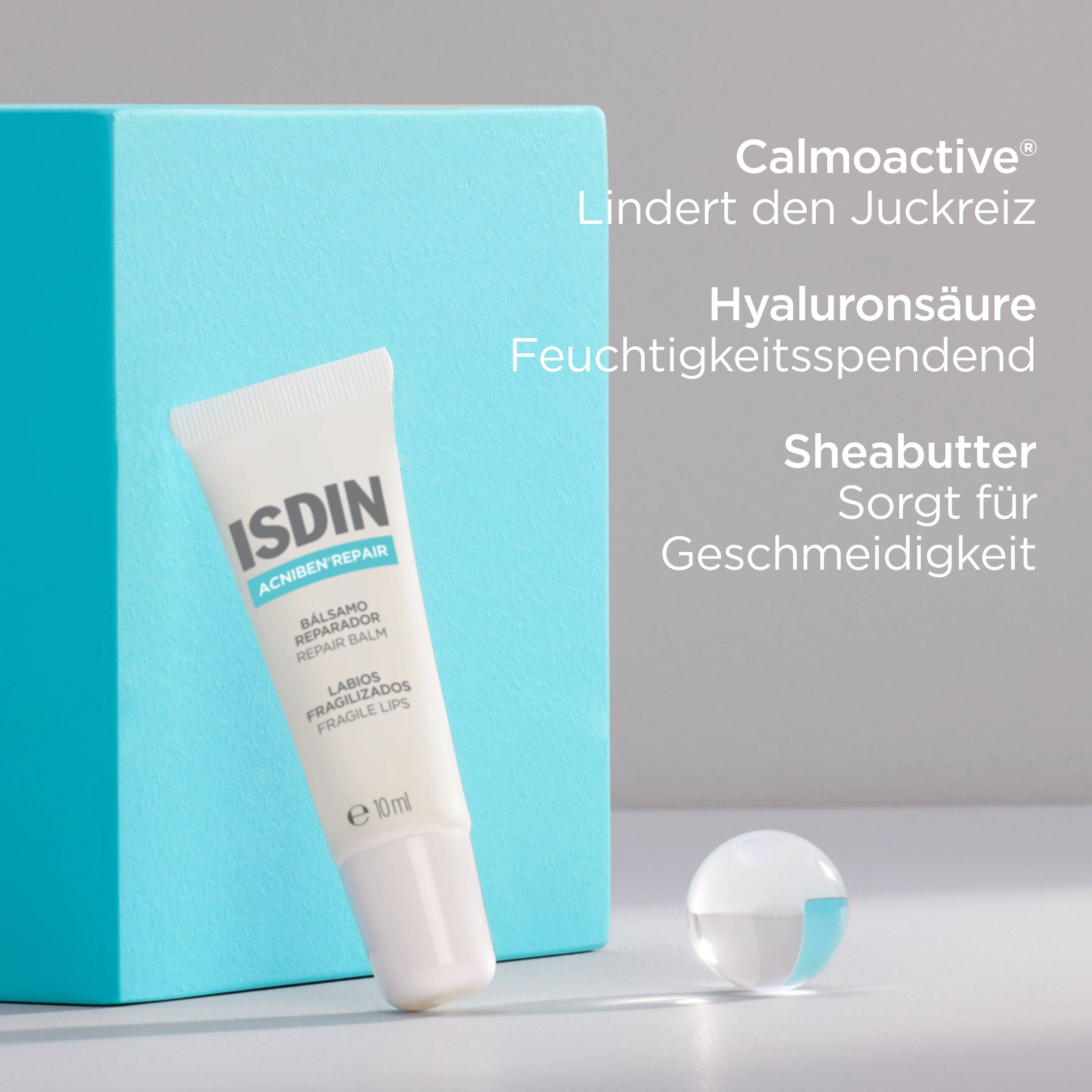 Tube ISDIN Acniben Repair und blaue Box. Text: Calmoactive, Hyaluronsäure, Sheabutter.