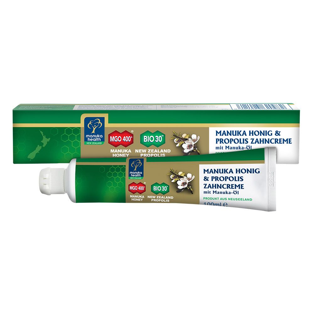 Zahnpasta-Tube und -Verpackung. Grün, weiß und goldfarben. Text: MANUKA HONIG & PROPOLIS ZAHNCREME.
